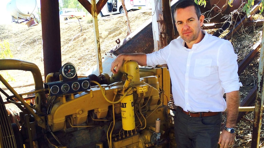 Water compliance executive Grant Barnes stands by an irrigation pump on the river at Bourke