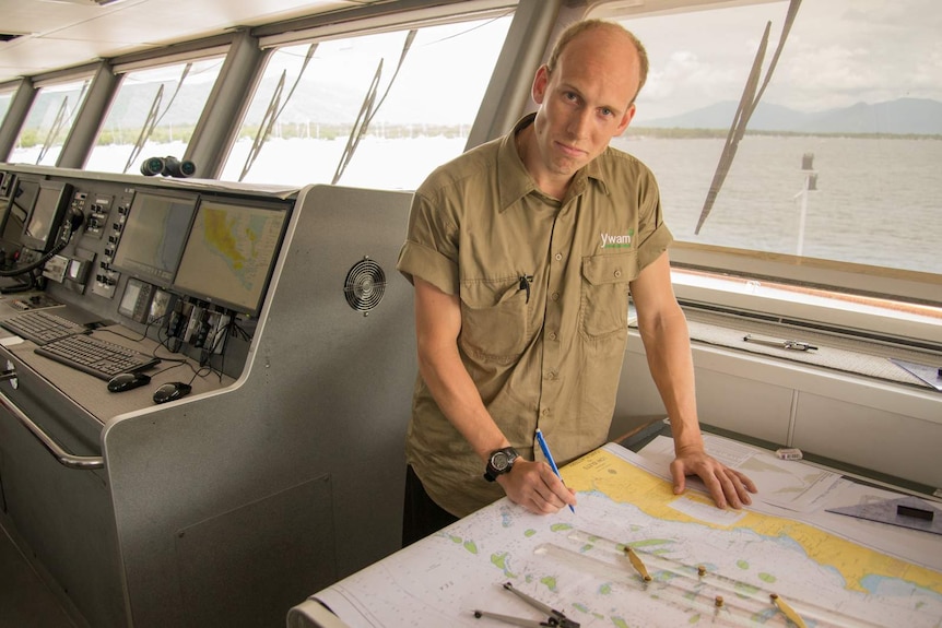 Jan Alnes stands over the navigation chart in the wheelhouse of the MV YWAM PNG.