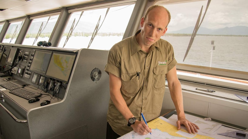 Jan Alnes stands over the navigation chart in the wheelhouse of the MV YWAM PNG.