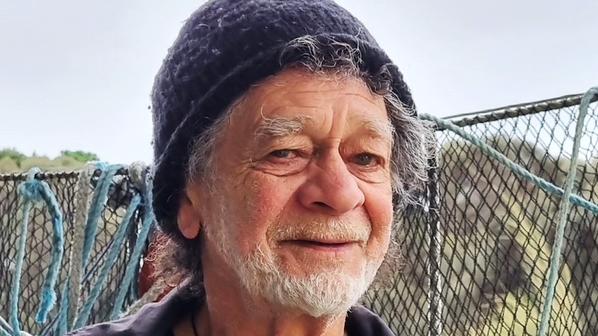 Jim is an elder Aboriginal man with a short grey beard and wearing a beanie.