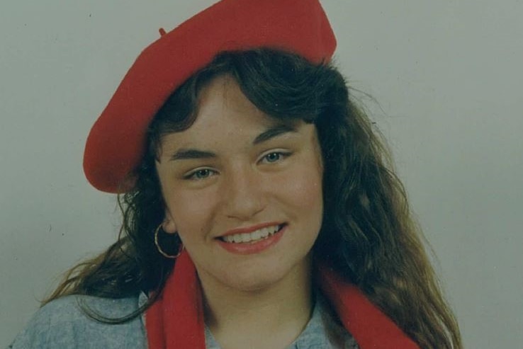 Portrait of Sarah Gatt wearing a red beret and scarf
