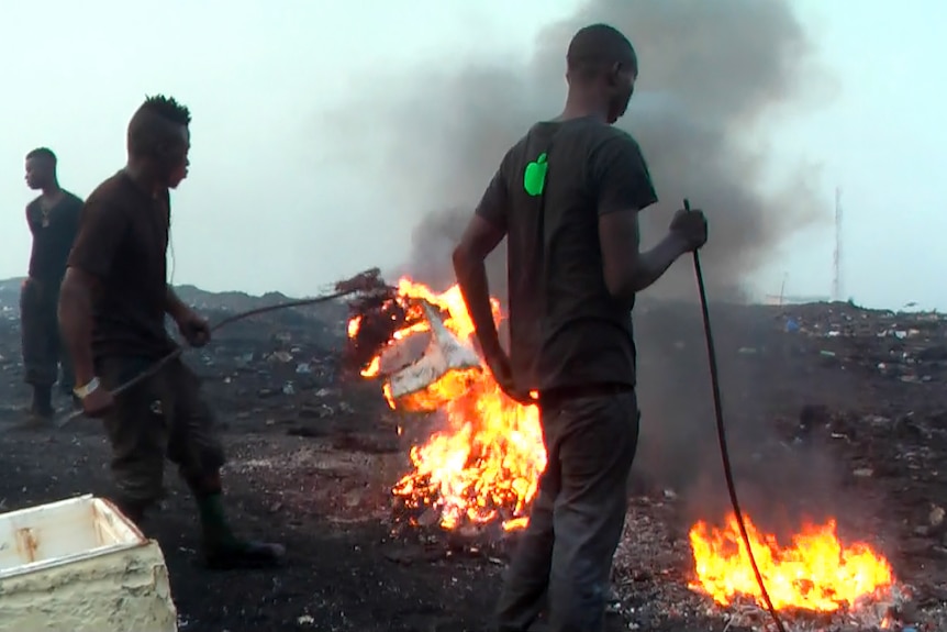 Boys burning e-waste at Agbogbloshie dump.