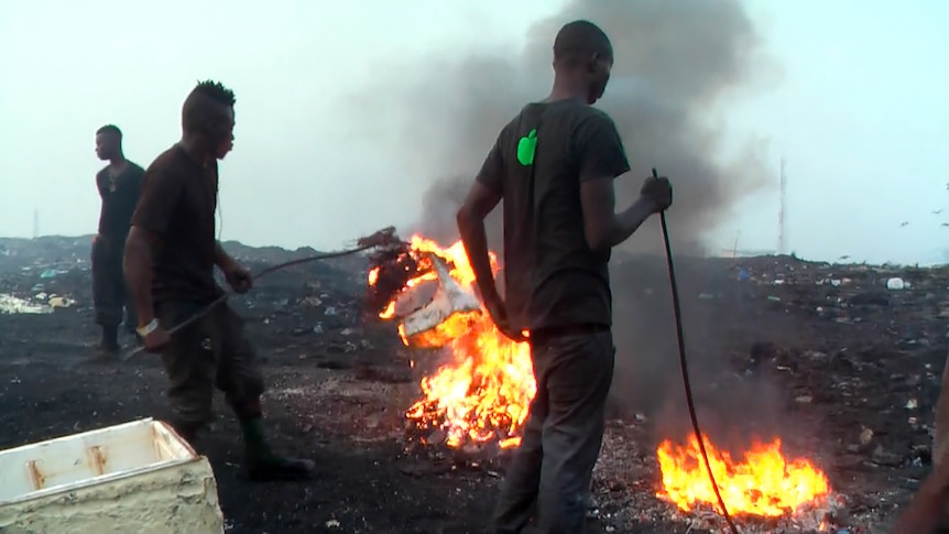 Boys burning e-waste at Agbogbloshie dump.