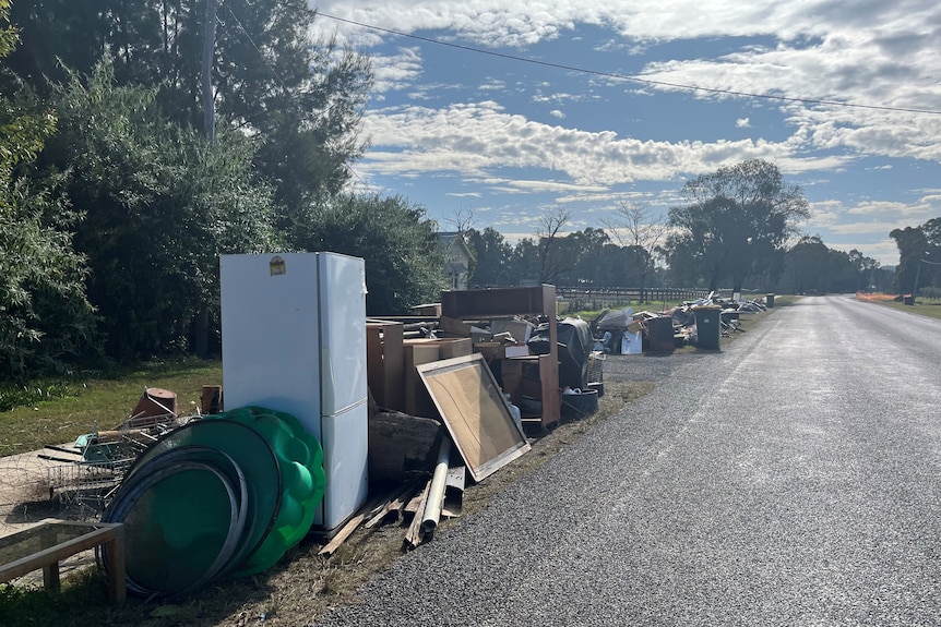 Damaged items line a road.