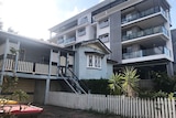 A Queenslander house beside a new apartment building at Lutwyche on Brisbane's northside.