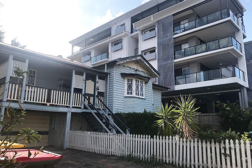 A Queenslander house beside a new apartment building at Lutwyche on Brisbane's northside.