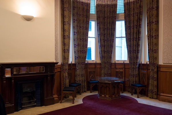 A quiet corner of the boardroom, with round table and fireplace.