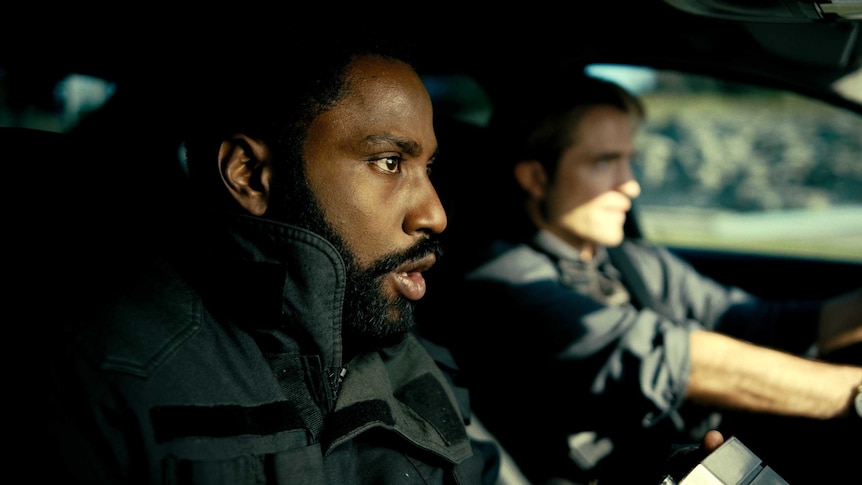 John David Washington and Robert Pattinson confront each other in a scene from the film Tenet