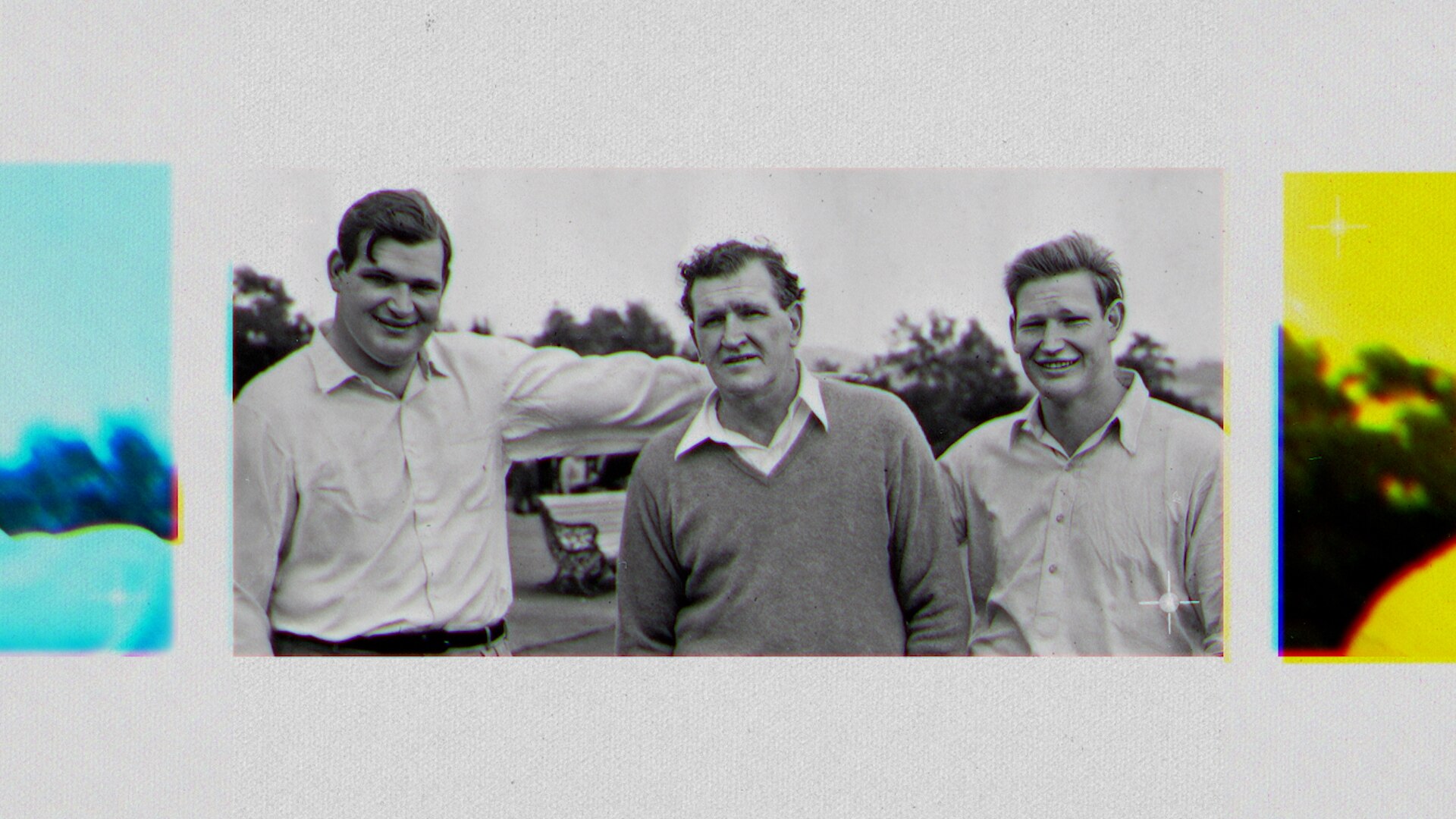 A black-and-white image shows an older man standing between two younger ones.