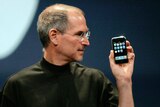 Apple CEO Steve Jobs holding the first generation iPhone