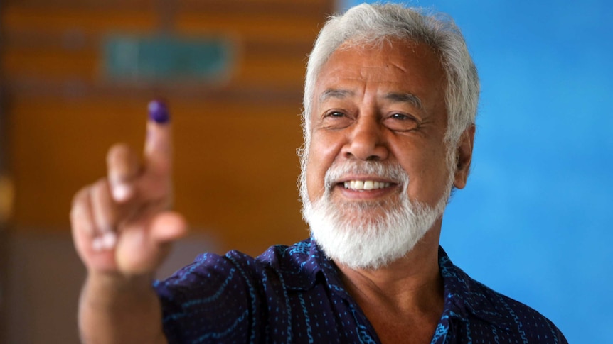 Xanana Gusmao shows his ink stained finger.