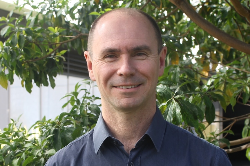 Professor Greg Leslie headshot in front of a tree