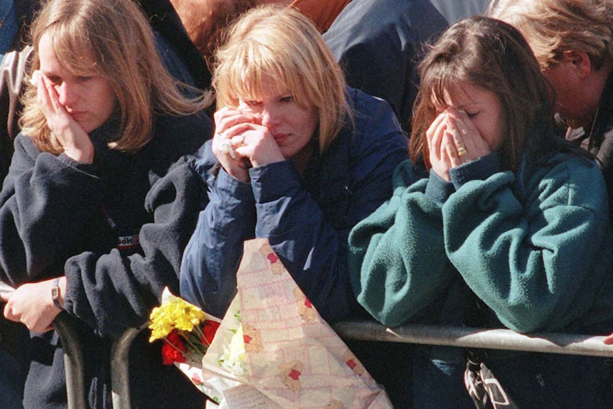 Members of the British public cry as the coffin of Diana, Princess of Wales, passes