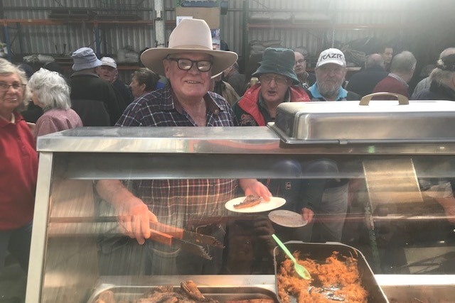 Dennis Turner enjoys a bite and a catch up with friends at this year's Old Mates Day.