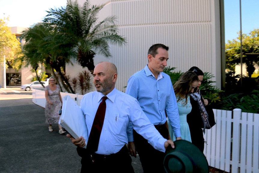 Paul Mossman (centre) arrives at Darwin Magistrates Court with lawyer John Adams (left)