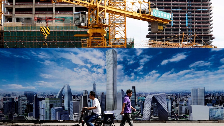 A construction site wall depicting the skyline of the Chinese capital in Beijing