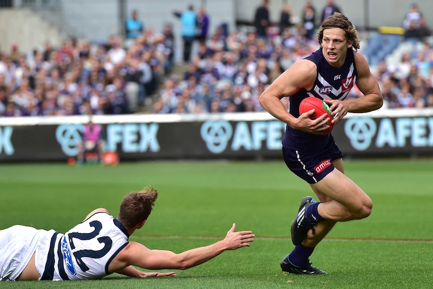 The Dockers' Nathan Fyfe runs with the ball during the Geelong versus Fremantle round two AFL match at Kardinia Park in Geelong.