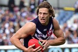The Dockers' Nat Fyfe runs with the ball against Geelong in round two, 2015 at Kardinia Park.
