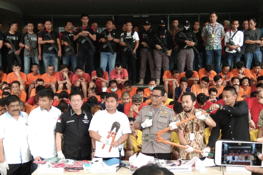 Jakarta Police Chief Inspector-General Idham Aziz holds a press conference in front of prisoners.
