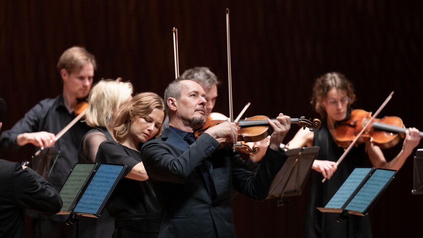 Director and violinist Richard Tognetti with members of the ACO.