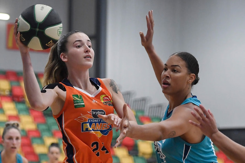 Sydney Uni Flames' Anneli Maley looks to pass past Southside Flyers' Liz Cambage.