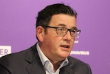 Daniel Andrews at coronavirus press conference with his hands out.