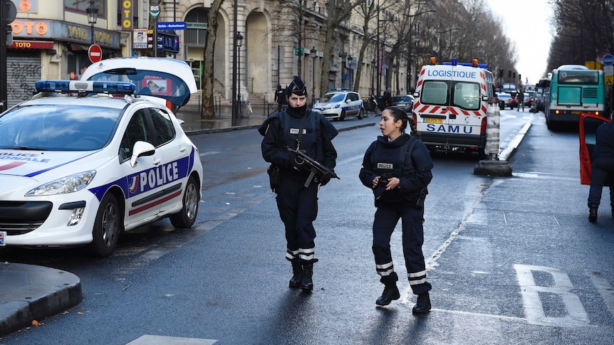 Armed French policewomen on a street.
