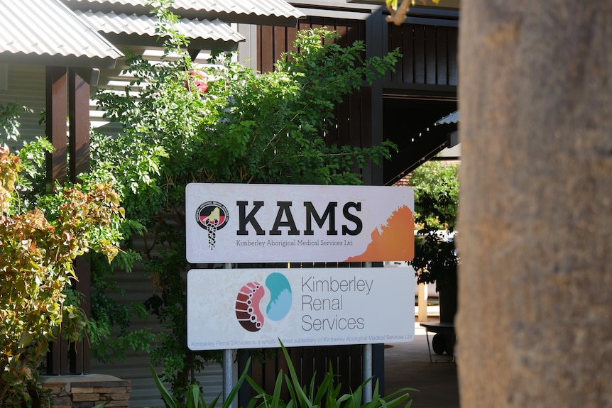 The KAMS Broome office sign in a shady, leafy garden.