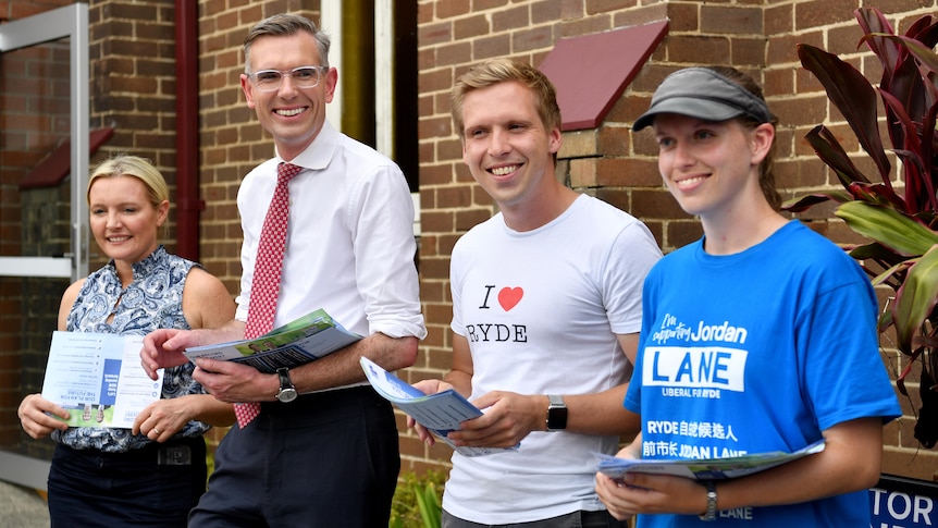 Four people handing out flyers