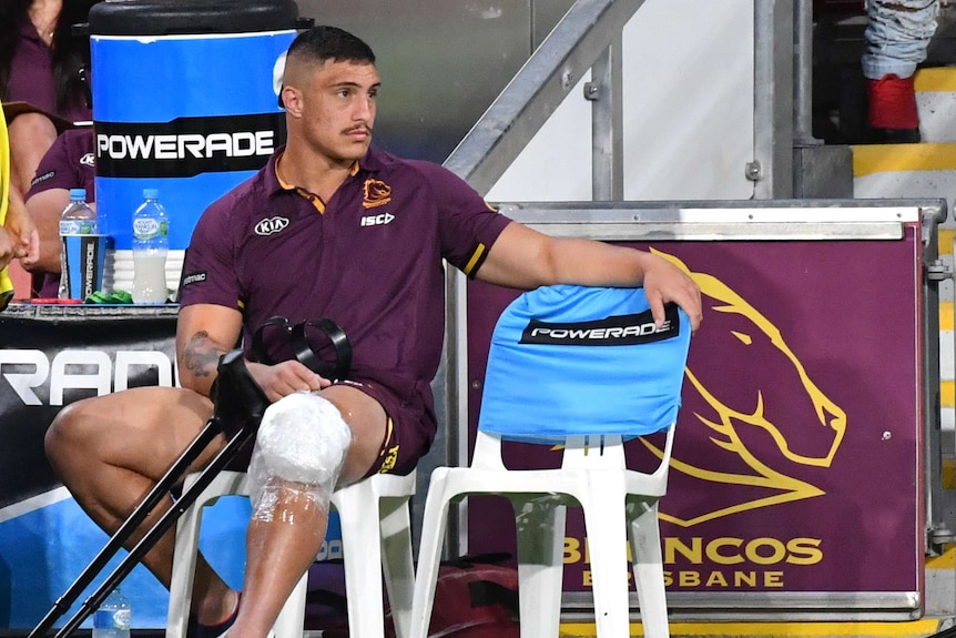 Kotoni Staggs sits injured on the sideline during the Brisbane Broncos' last game of the 2020 NRL season.