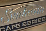 A Sunbeam logo on a coffee machine.
