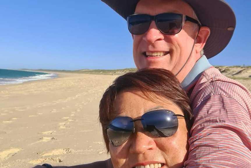 A man and woman on a beach.