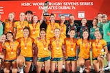 Australia women's rugby sevens team gather for a photo with the trophy