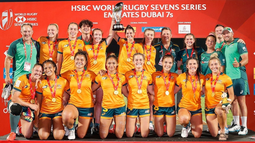 Australia women's rugby sevens team gather for a photo with the trophy
