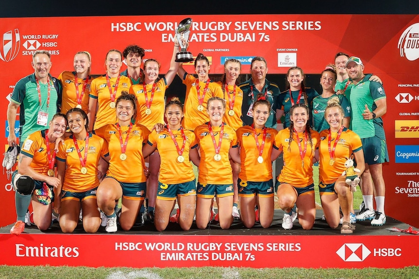 Australia women's rugby sevens team gather for a photo with the trophy