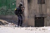 Israeli soldier aims weapon at building