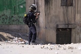 Israeli soldier aims weapon at building