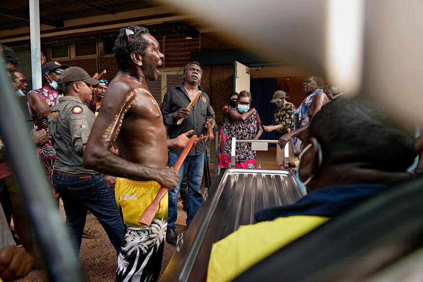 Aboriginal family and friends perform at a funeral ceremony