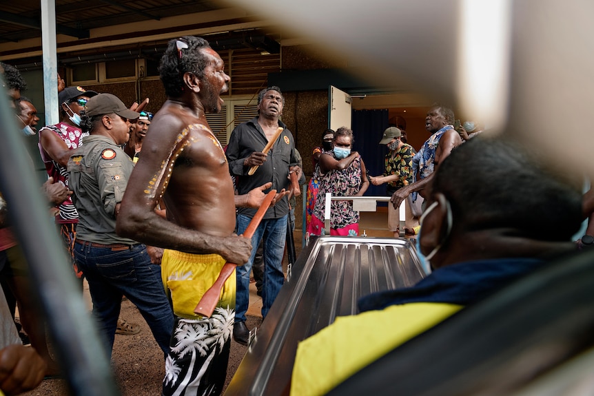 Aboriginal family and friends perform at a funeral ceremony