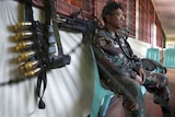 Polls open: A soldier sits outside a voting centre in Manila