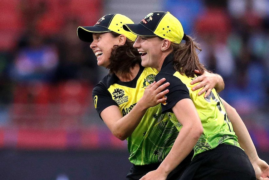 Australia bowlers Molly Strano and Annabel Sutherland in a joyous, running embrace during a T20 World Cup match against India.