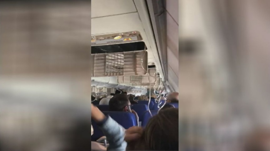 Oxygen masks dropping on board a Southwest Airlines flight after an engine blew.