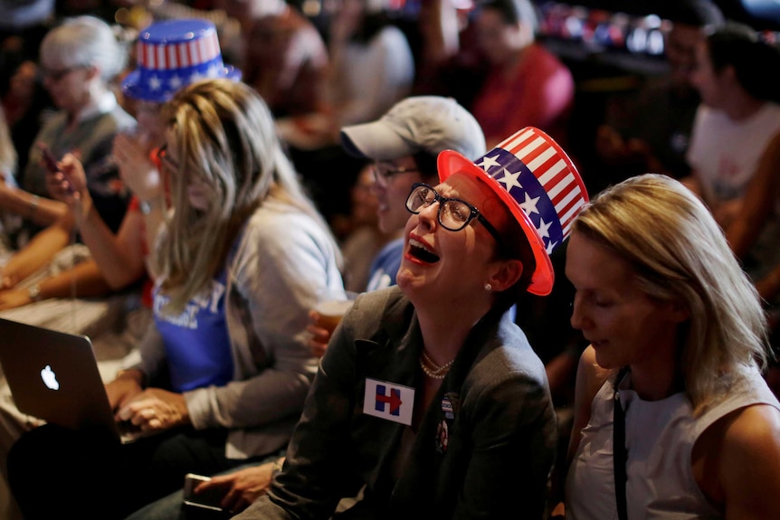 A Democrat supporter reacts as results come in favour of Trump