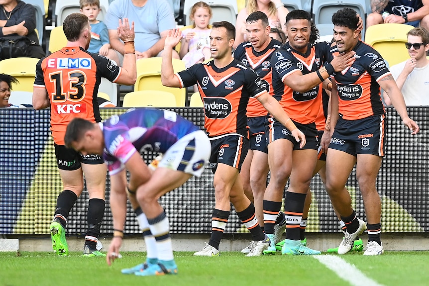 Luke Brooks and the Wests Tigers celebrate a try against the Cowboys.