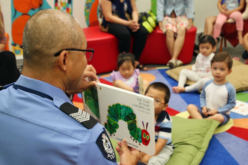 Police officer reads book to children