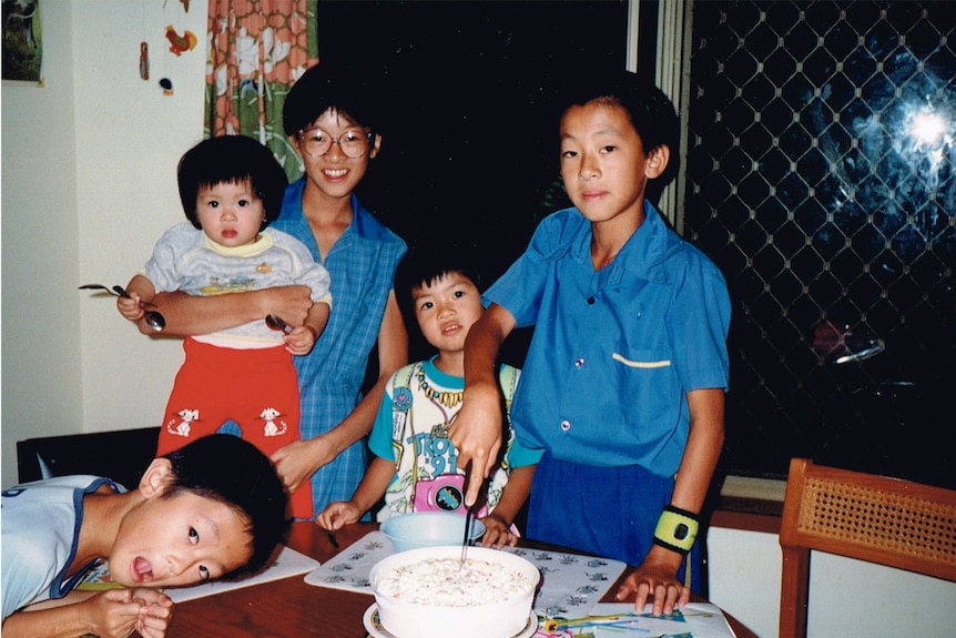 Five kids standing together looking at the camera