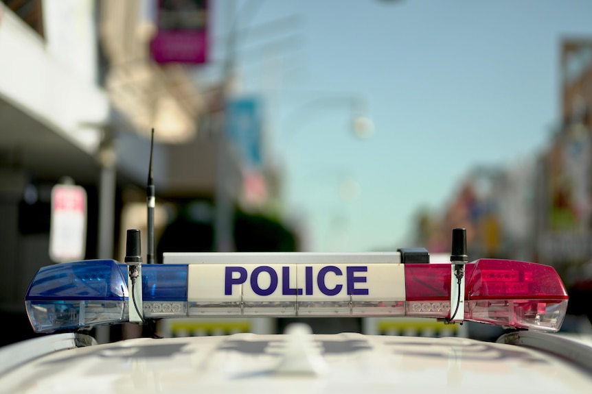 The lights on top of a police car in an Adelaide street.