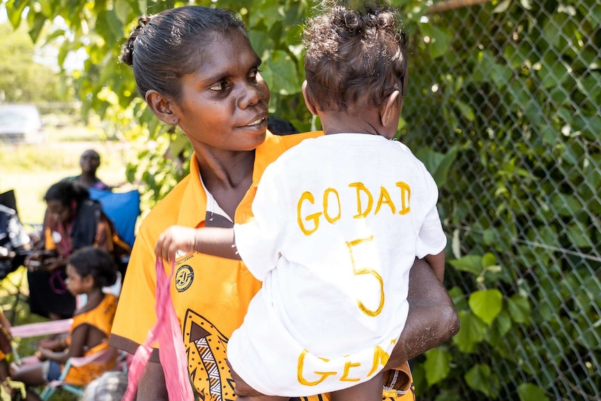 Nikita Tipiloura and her daughter show their support for the Tapalinga Superstars.