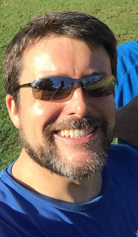 A man smiles at the camera 