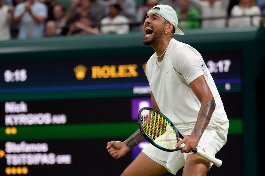 A man celebrates winning a tennis match